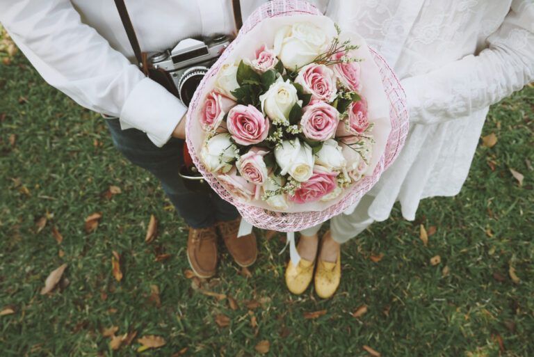 couple holding wedding bouquet